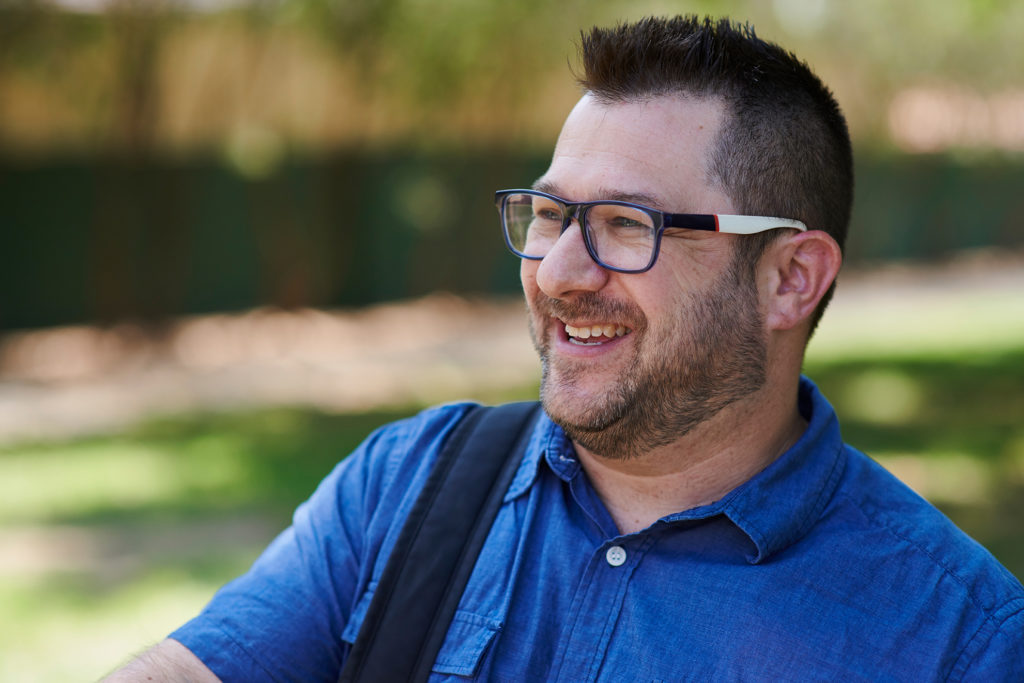 Guy with glasses and blue shirt