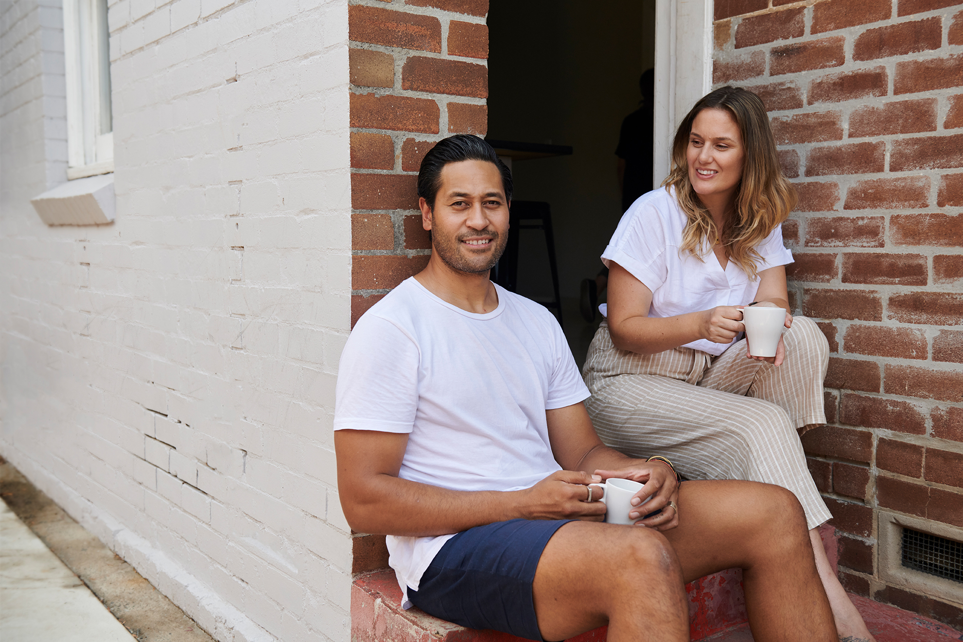 man and woman sitting on porch