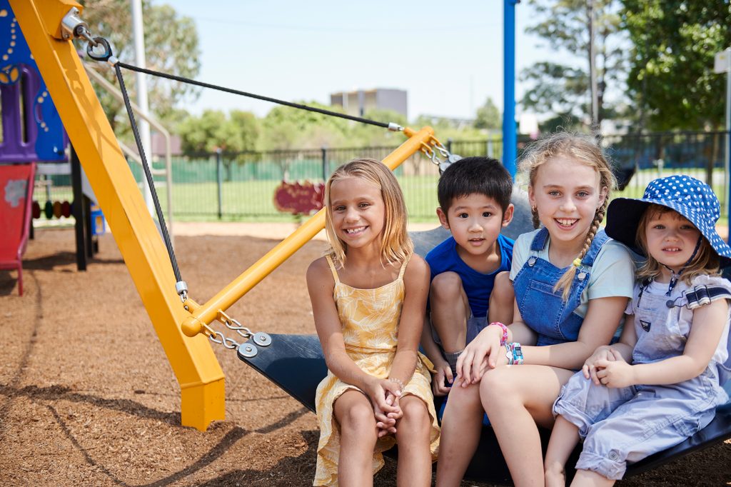 young children sitting in a playground