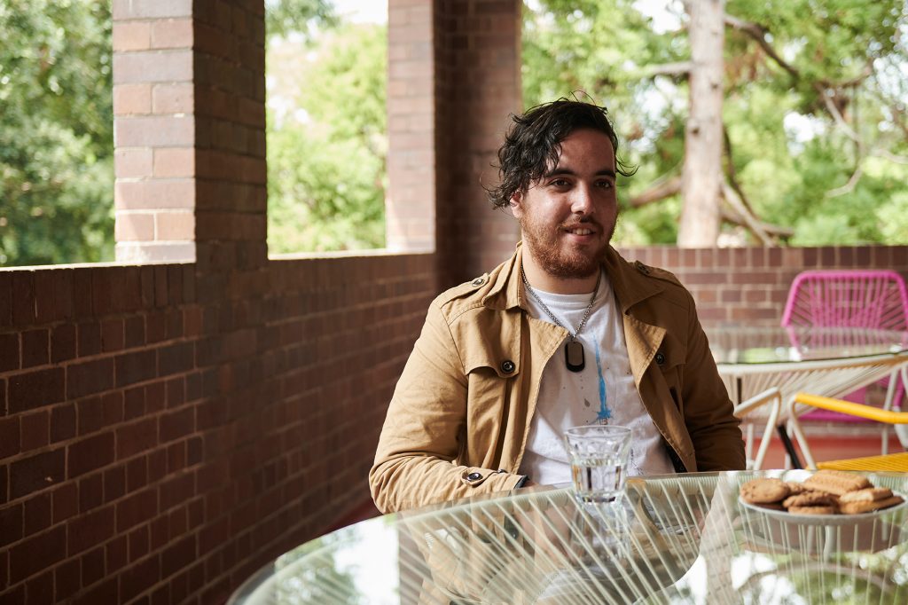 young man sitting down