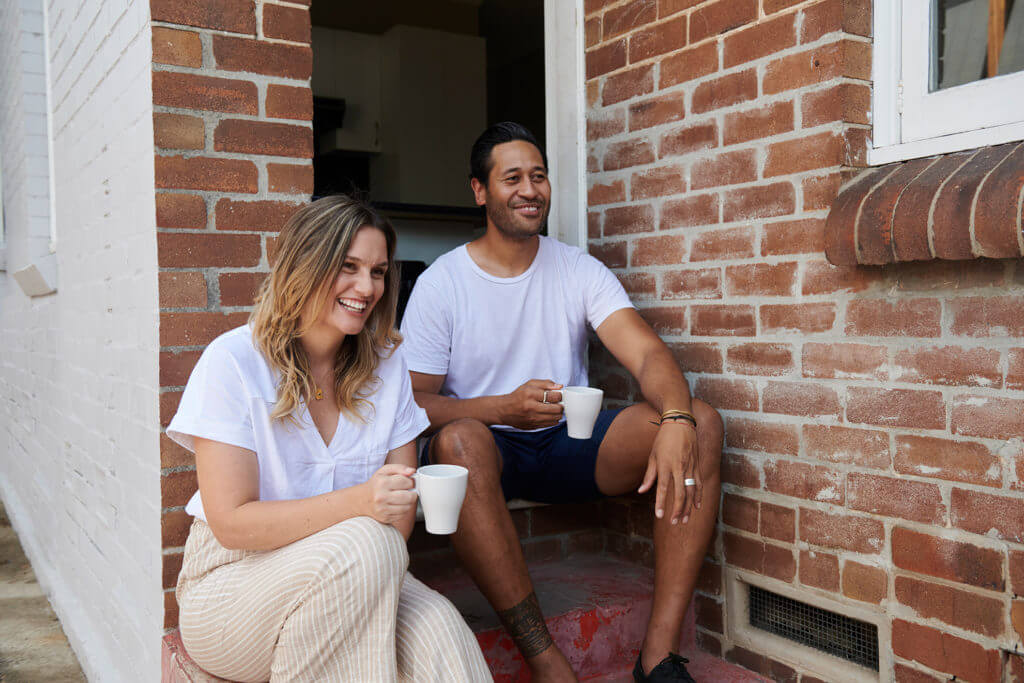 Woman and man drinking tea outside