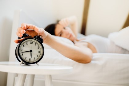 girl sleeping and alarm clock