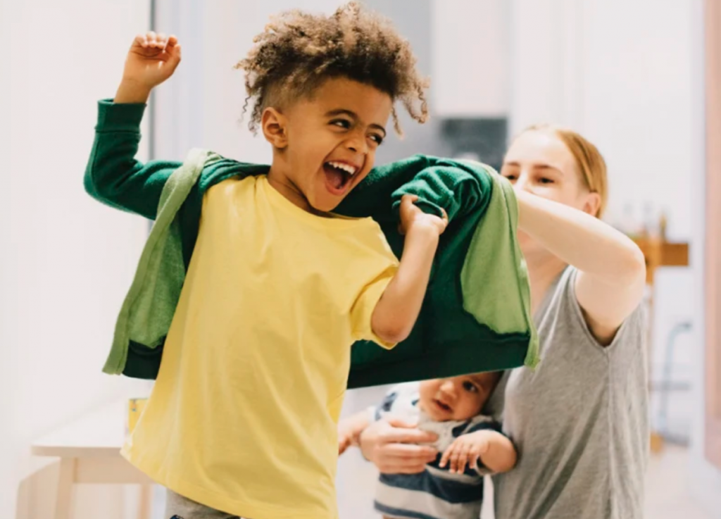 image of child self helping themselves by putting on clothes