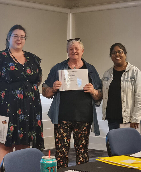 Helen holding are graduation certification