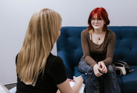 a client and visitor talking in a consult room