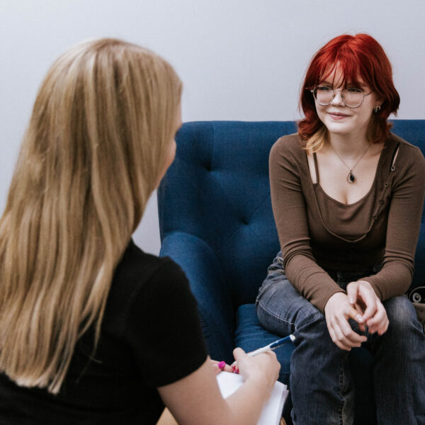 a client and visitor talking in a consult room