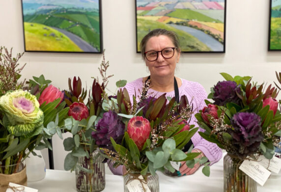 Cassandra is surrounded by bouquets at the florist where she works