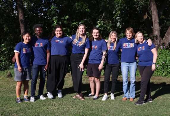 Stride team together smiling outside in the sunshine