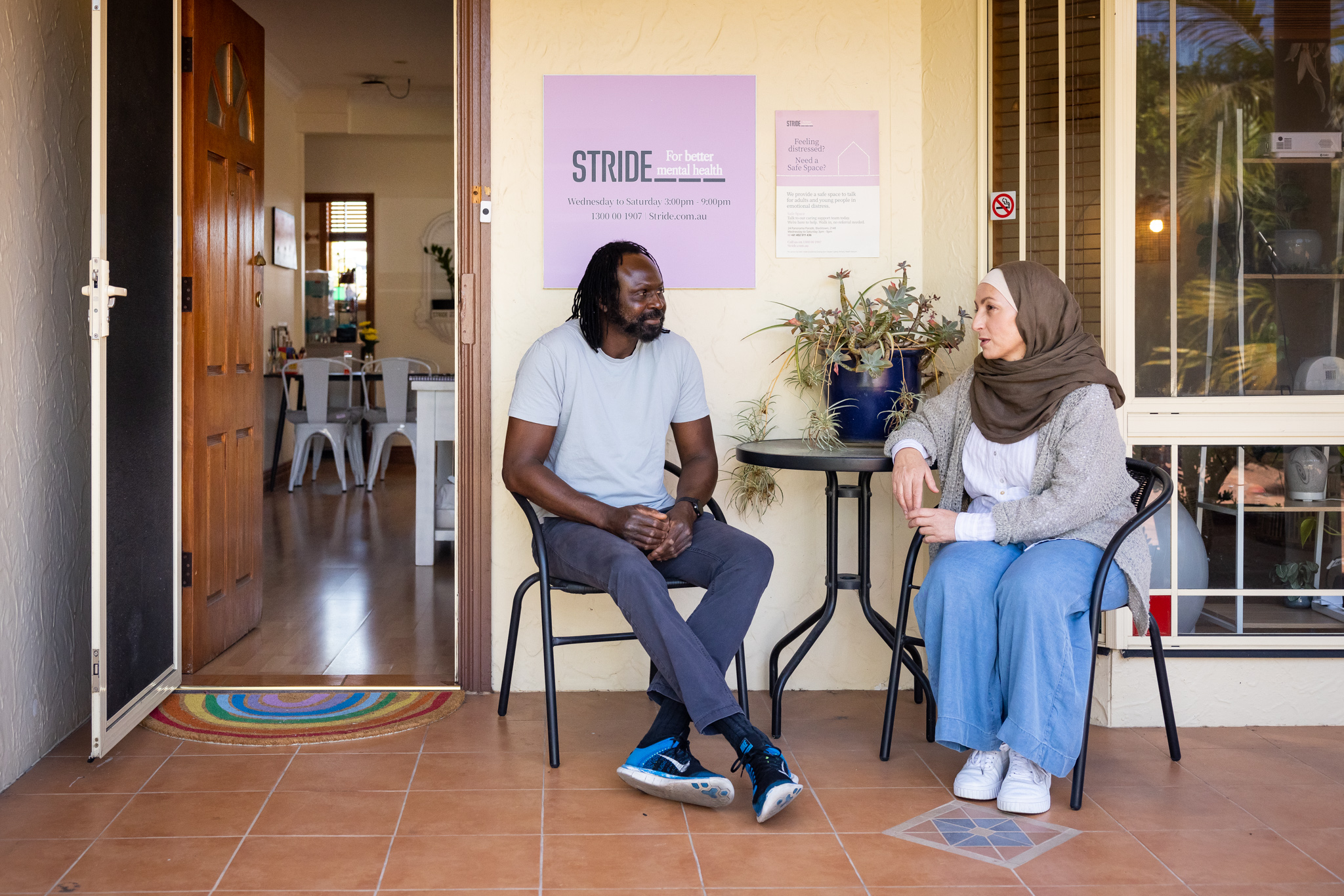 Man and woman sitting on the porch of a Safe Space