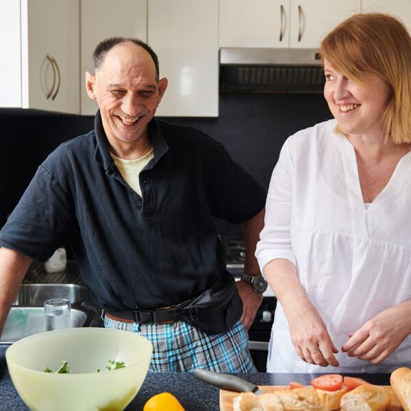 Woman and man in kitchen cooking dinner