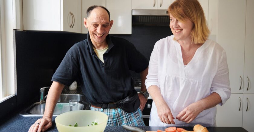 Woman and man in kitchen cooking dinner