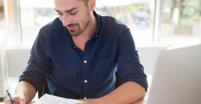 Man sitting at table writing