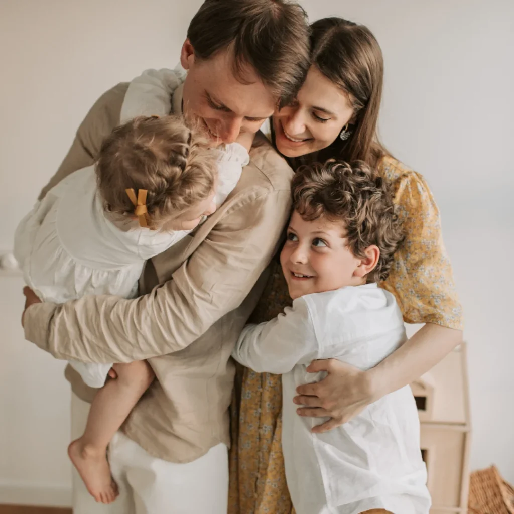 Family with kids hugging and smiling