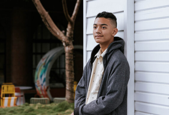 Teen leaning on wall