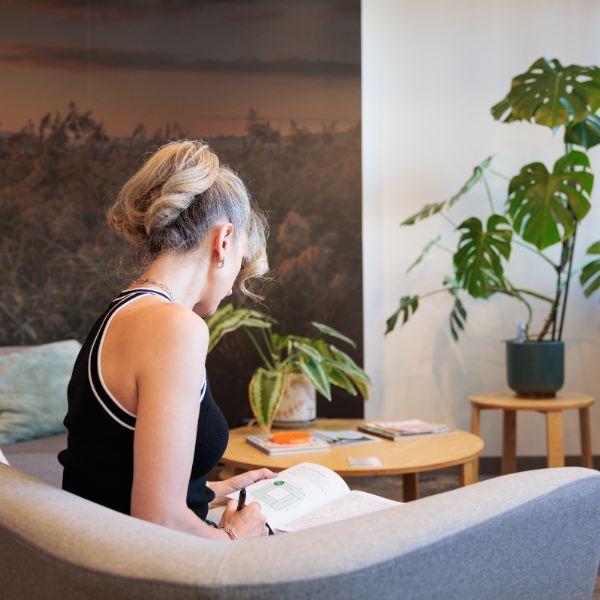 Person sitting down on lounge reading how to box breath
