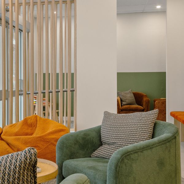 Lounge area with comfortable single chairs with cushions and bean bags