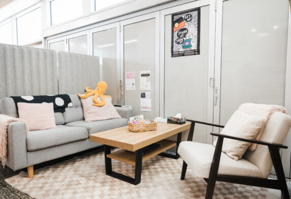 Soft grey, oak and dark wooden lounge and sofa chair in a relaxed, secluded space