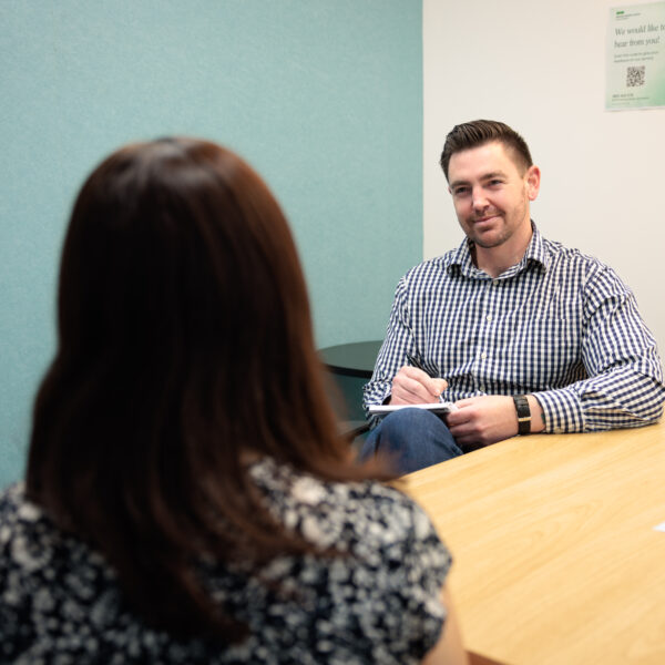 Peer worker and person talking in a room
