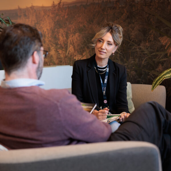 Peer worker talking to person on couch