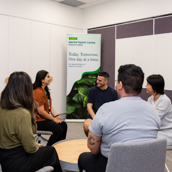 People sitting in a circle participating in a group session