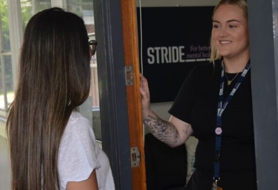 Safe Space Peer Worker greeting somebody at the front door