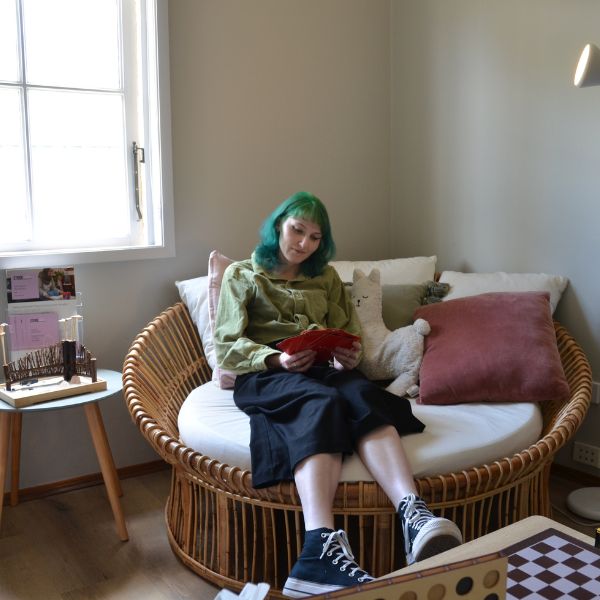 Comfortable large lounge chair in a calm space with person sitting and reading