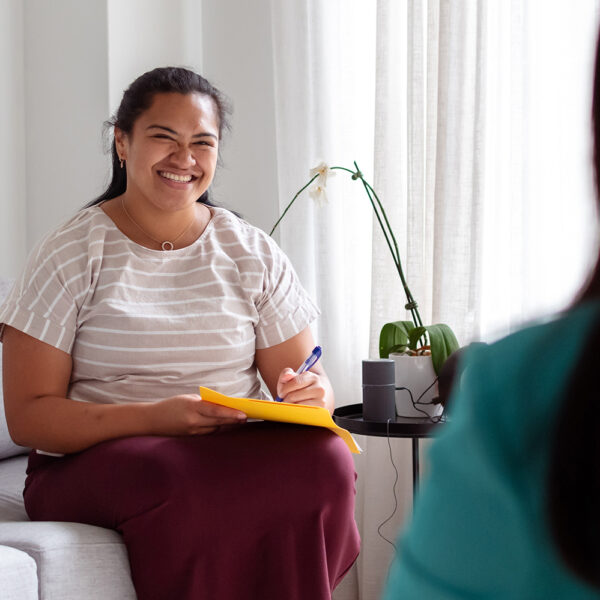 therapist smiling in consultation room