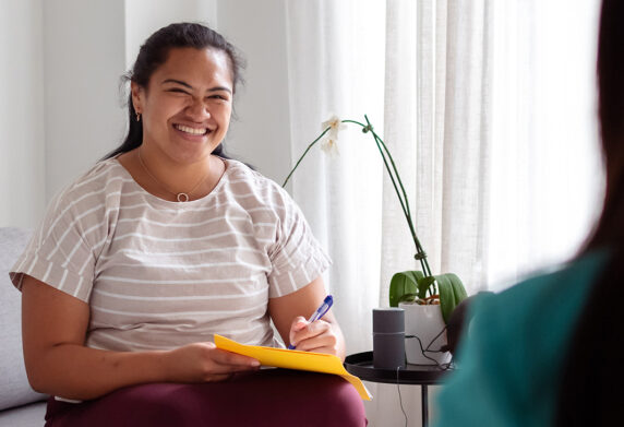 therapist smiling in consultation room