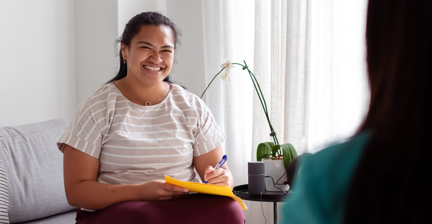 therapist smiling in consultation room