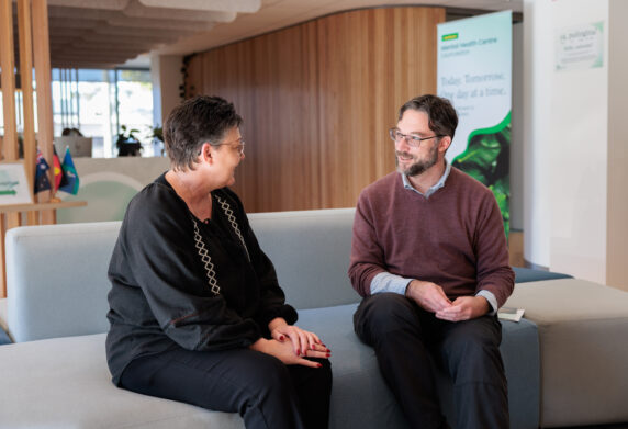 Greeted by a support worker in discussion on reception lounge