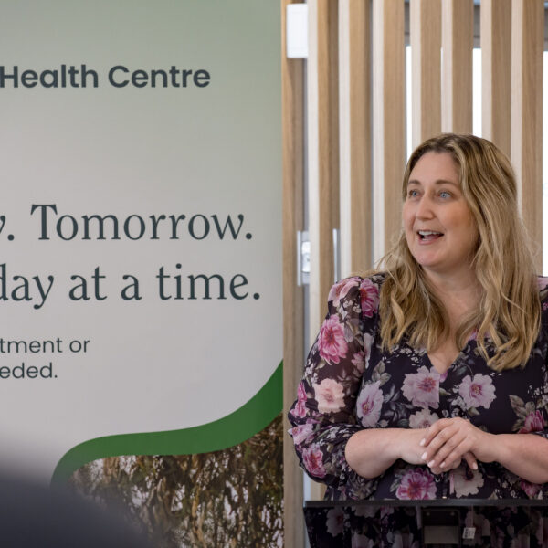 Hon Emma McBride, Assistant Minister for Mental Health and Suicide Prevention and Assistant Minister for Rural and Regional Health alongside the Dubbo pull up banner speaking