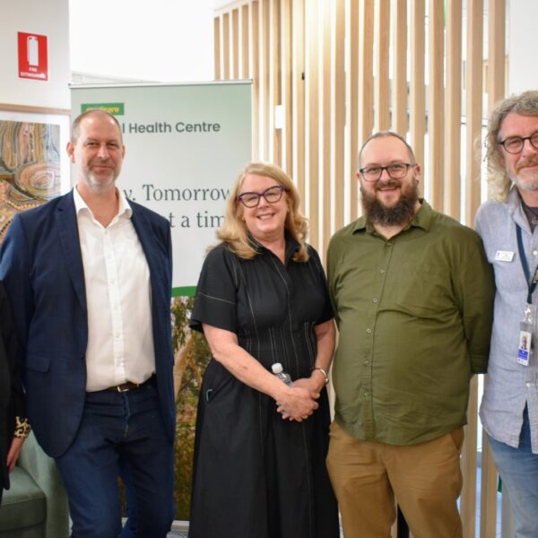 Stride CEO alongside MMHC team next to the Dubbo pull up banner