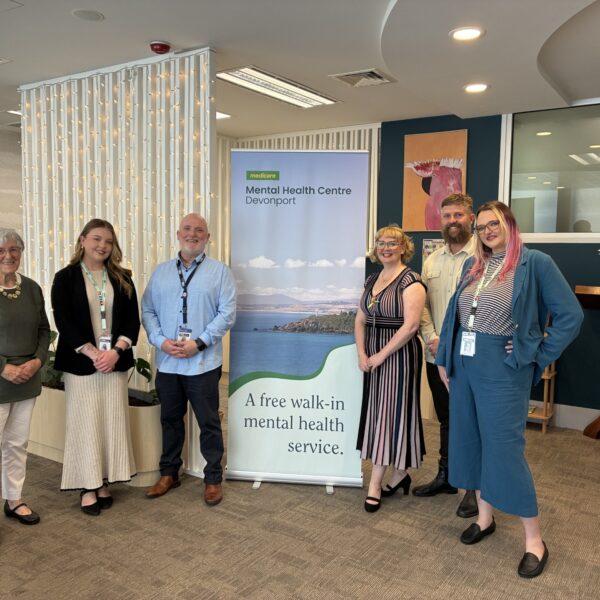 The Devonport MMHC team around their Devonport pull up banner