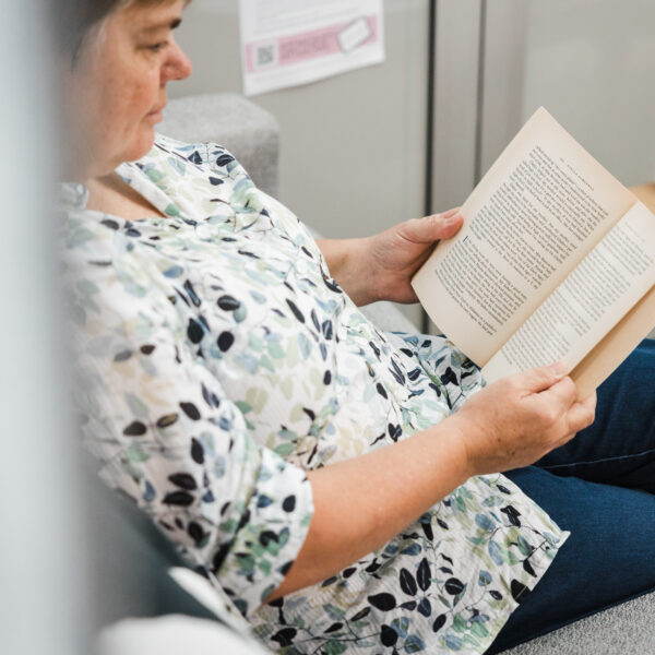Person quietly reading a book on the lounge